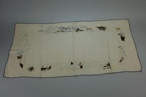 Image of Embroidered bureau scarf with scenes of MacMillan in arctic poses